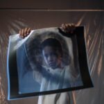 child holding a x ray film