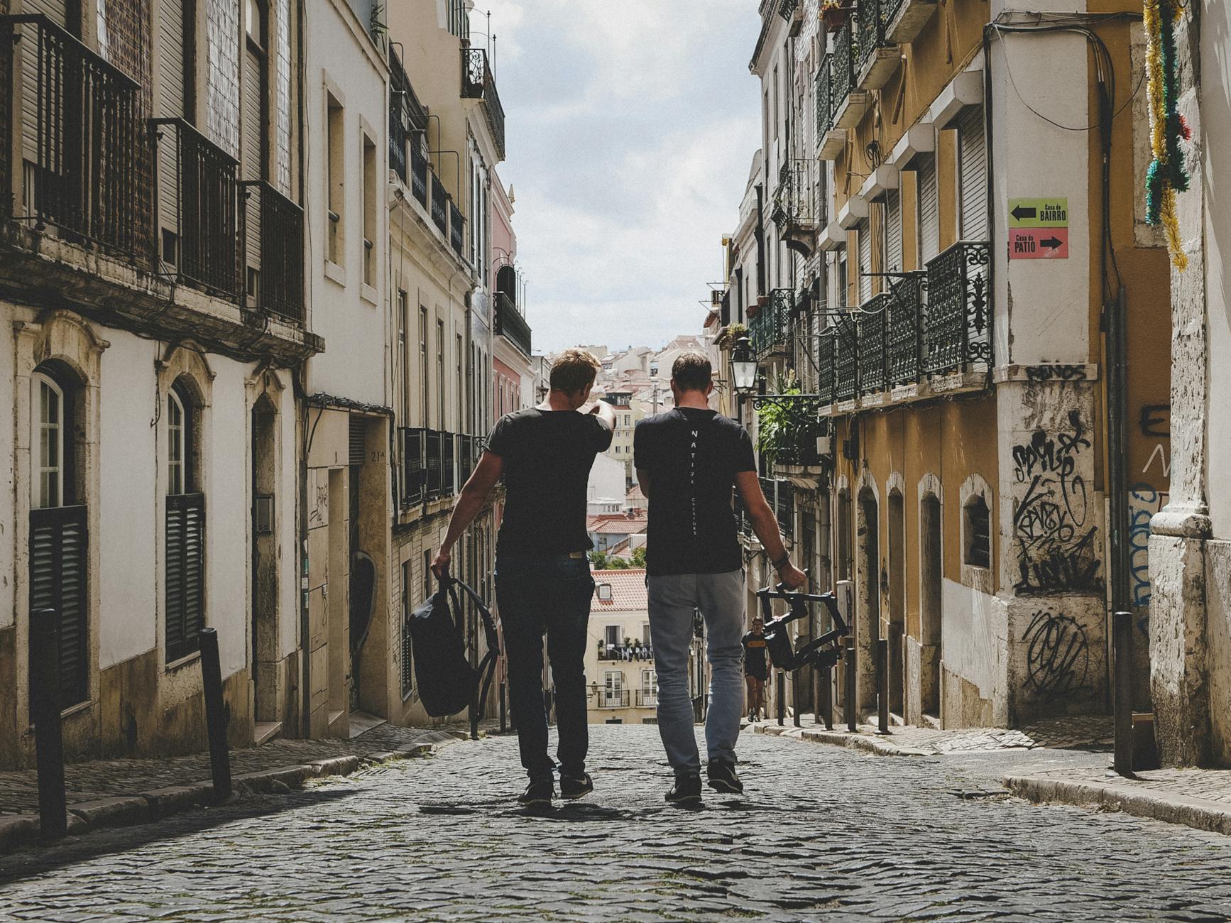 Mental Health: A Personal and Shared Responsibility two man walking in between of buildings toward with concrete building